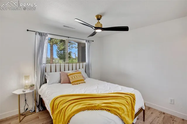 a bedroom with a bed and painting on the wall