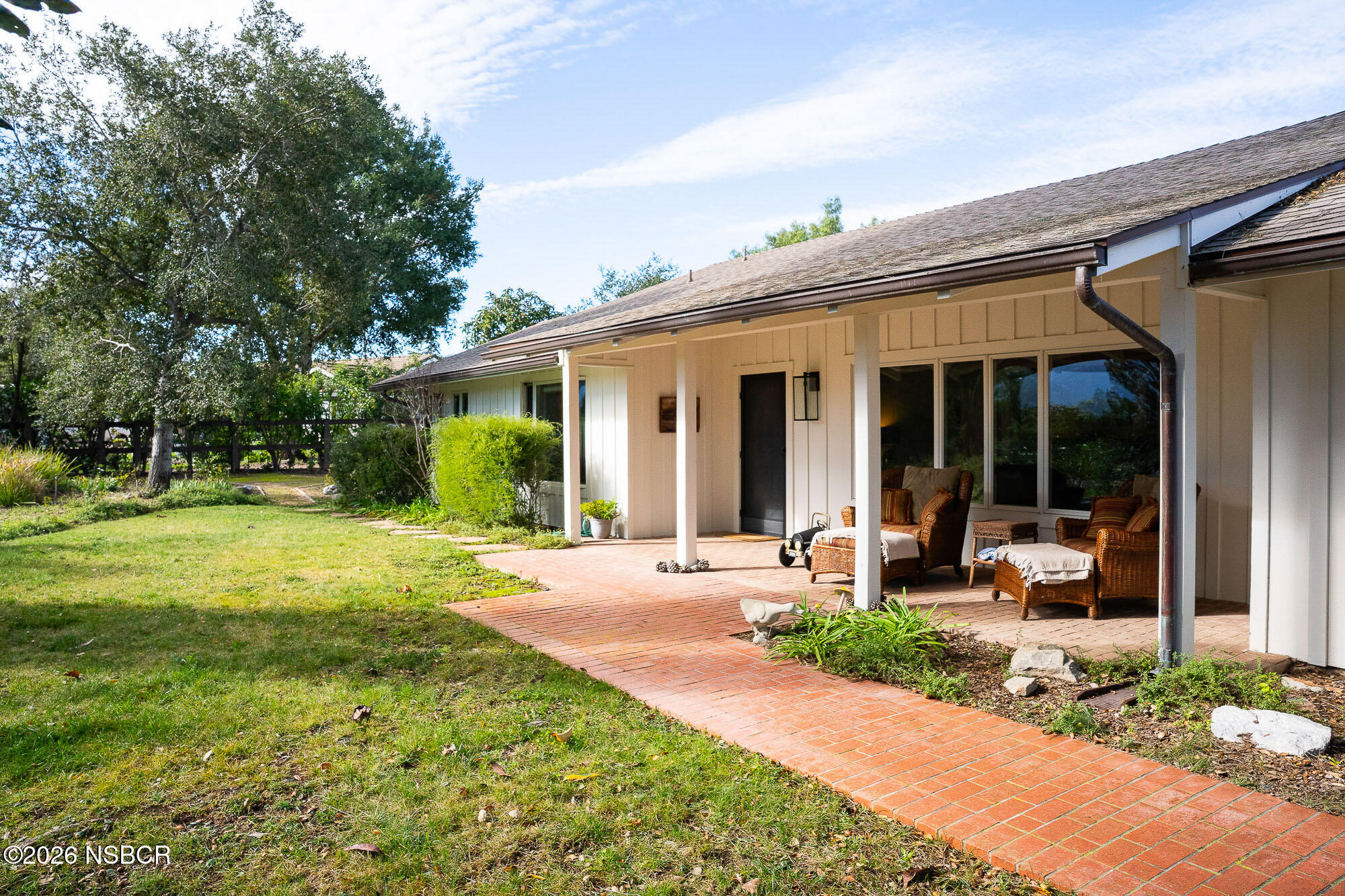 724 North Refugio Road Santa Ynez, CA 93460 - Photo 12 of 47 a front view of a house with a yard and porch