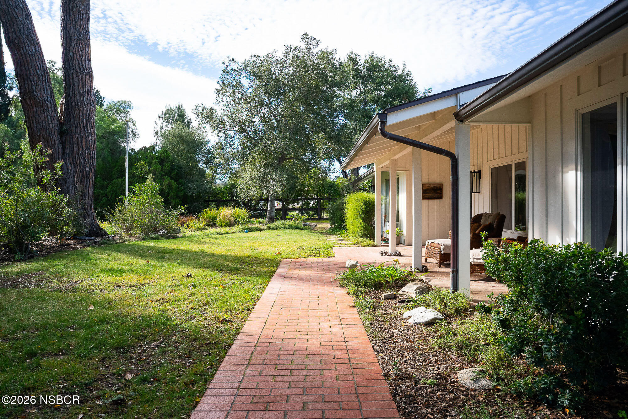 724 North Refugio Road Santa Ynez, CA 93460 - Photo 2 of 47 a view of a yard with plants and large trees