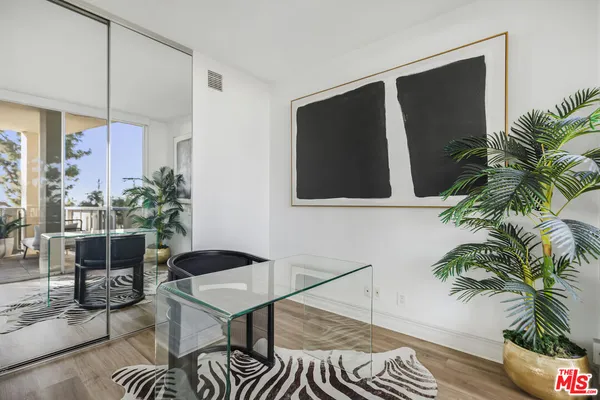 a living room with furniture a flat screen tv and a floor to ceiling window