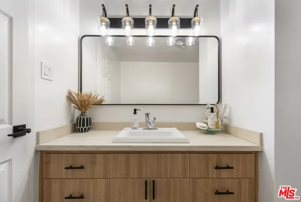 a bathroom with a sink and a mirror