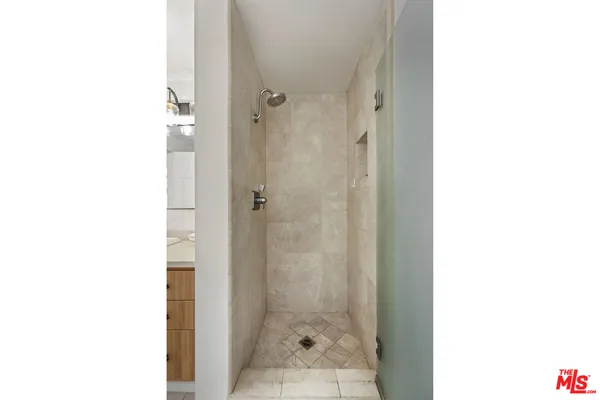 a bedroom with a bed and a potted plant on dresser