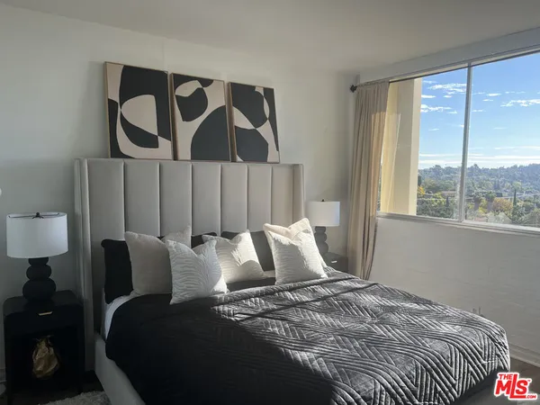 a bedroom with a bed and a window