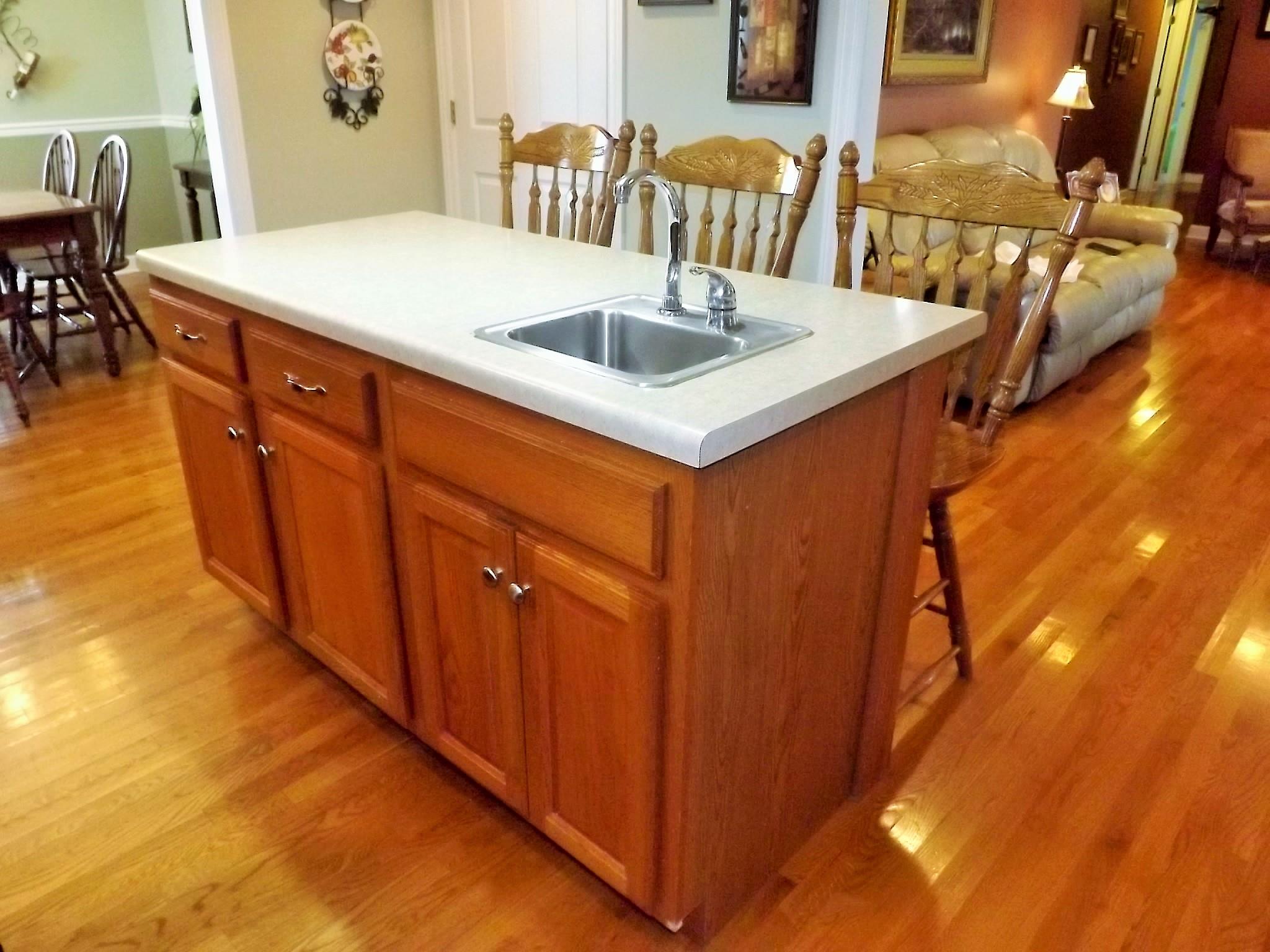 931 Hoodoo Road Beechgrove, TN 37018 - Photo 12 of 28 a kitchen with a sink a table and chairs