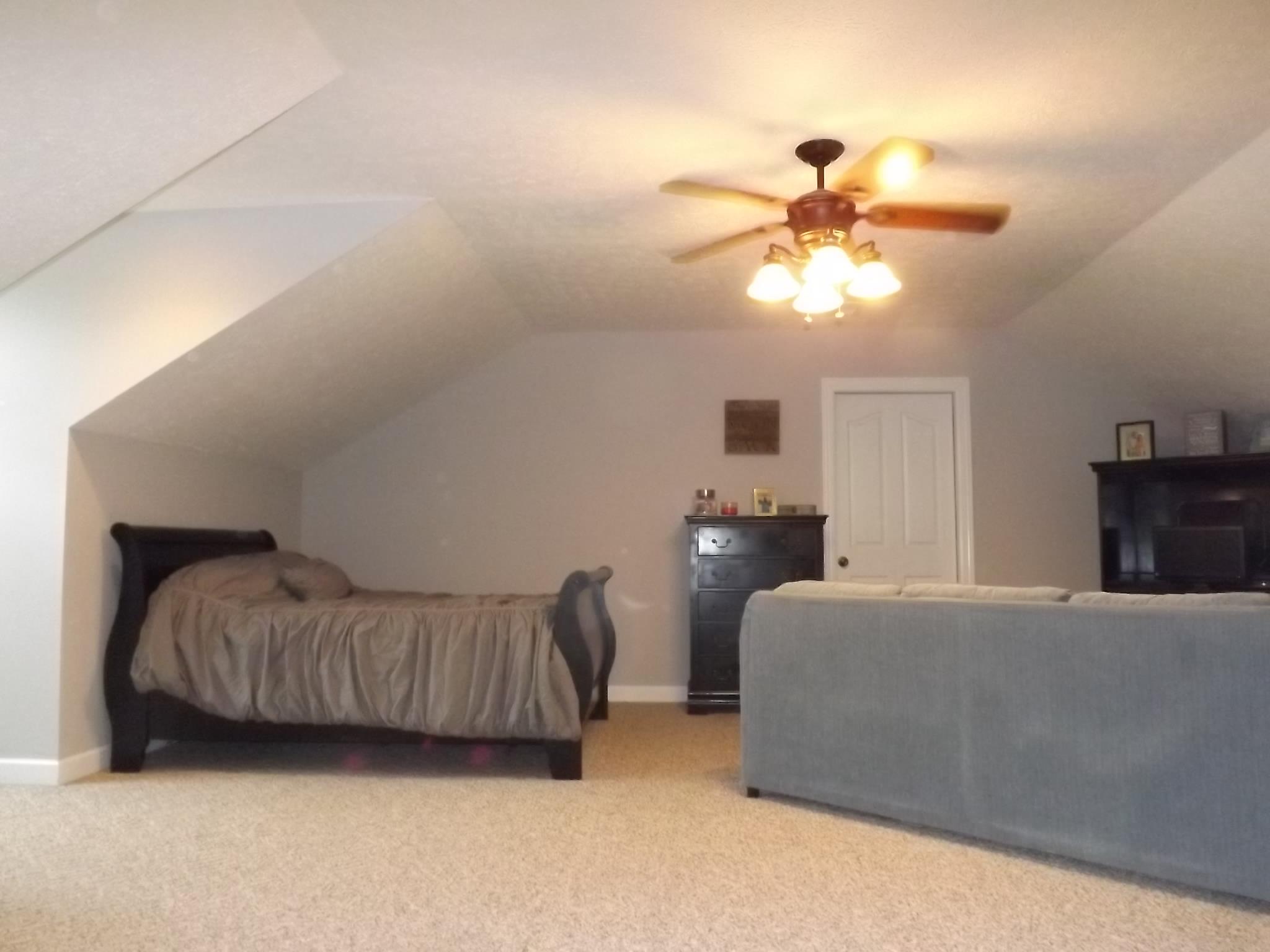 931 Hoodoo Road Beechgrove, TN 37018 - Photo 23 of 28 a bedroom with a bed and a chandelier