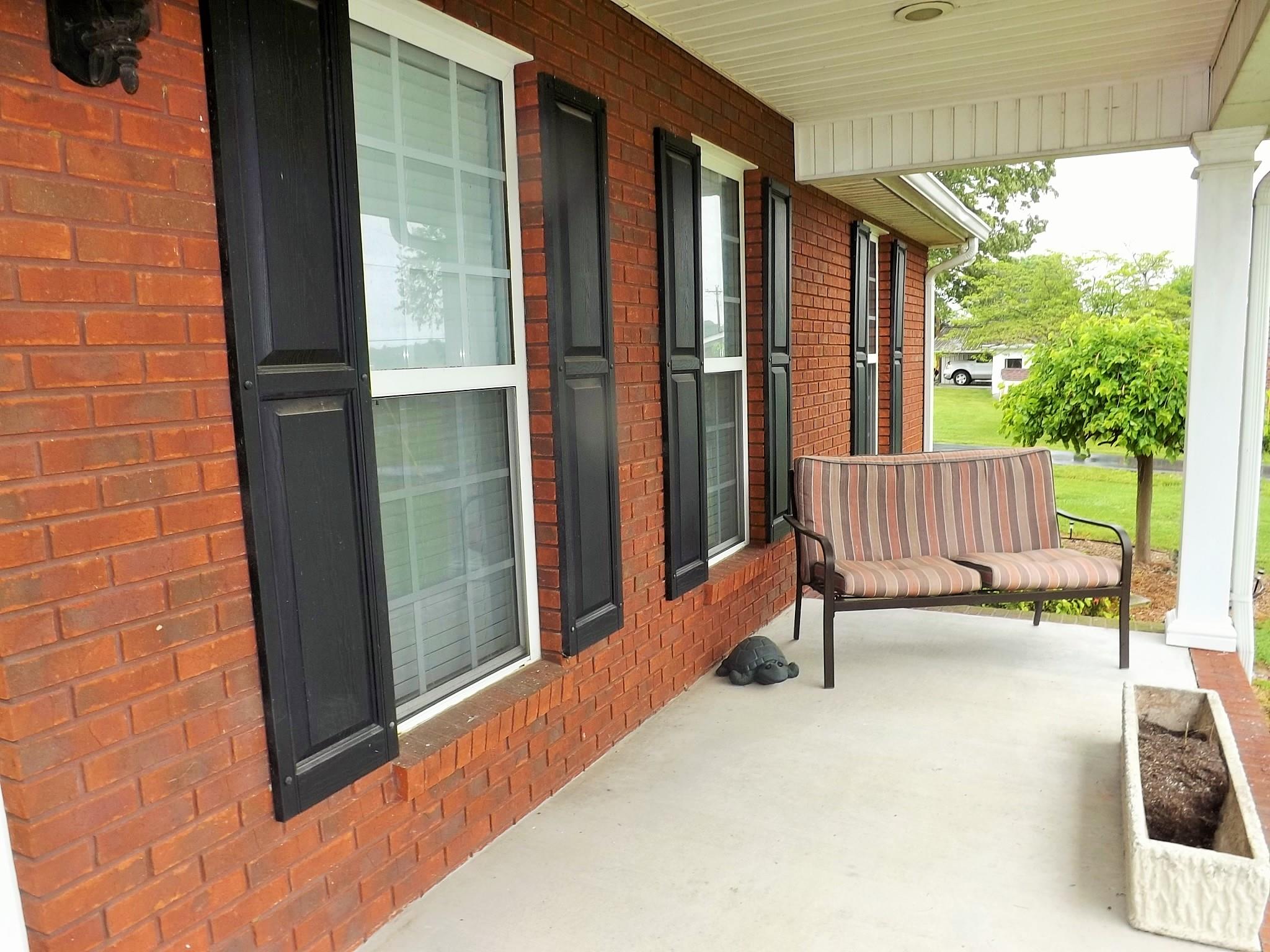 931 Hoodoo Road Beechgrove, TN 37018 - Photo 4 of 28 a view of a porch with a door and chair