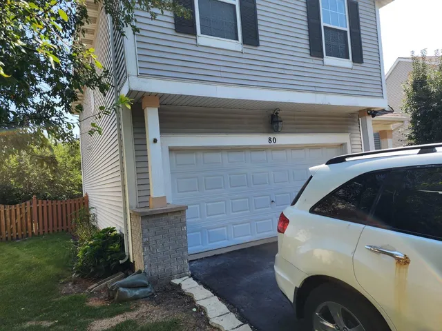 a view of a house with a sink and wooden fence