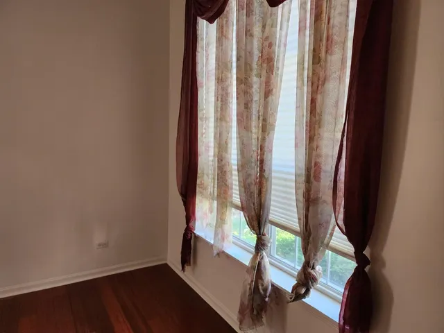 a view of a room with wooden floor and chair