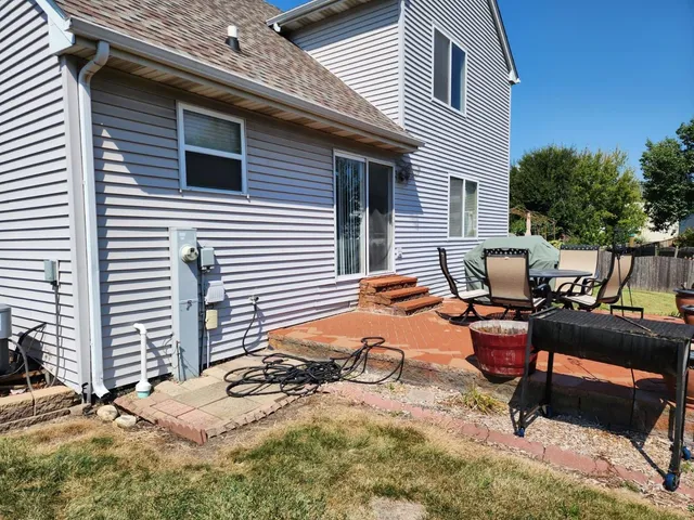 a view of a backyard with a table and chairs
