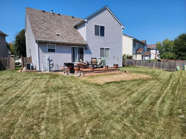 a view of a house with swimming pool and a yard