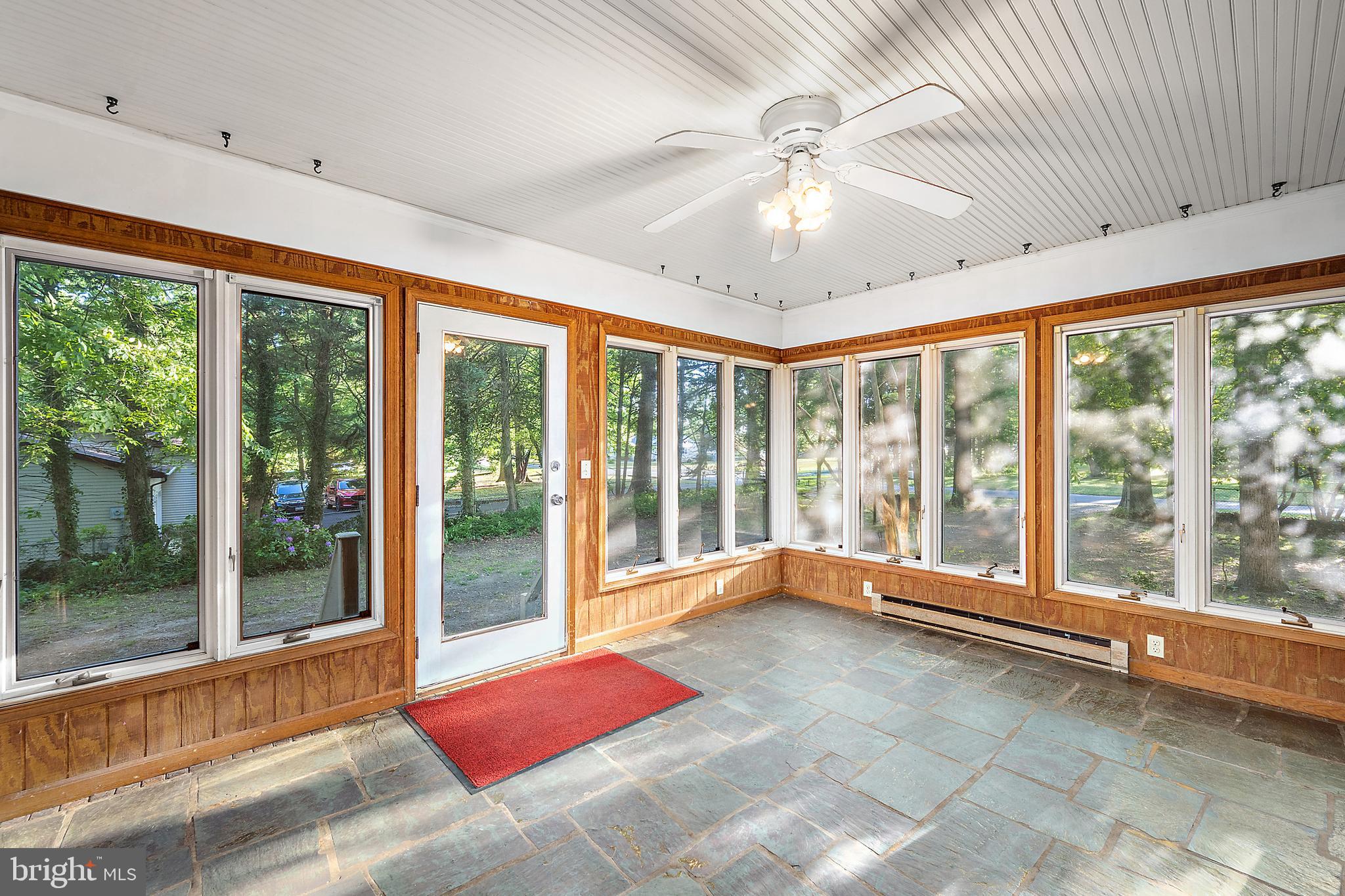 6181 Rockawalkin Road Salisbury, MD 21801 - Photo 52 of 65 a view of an empty room with wooden floor and a large window