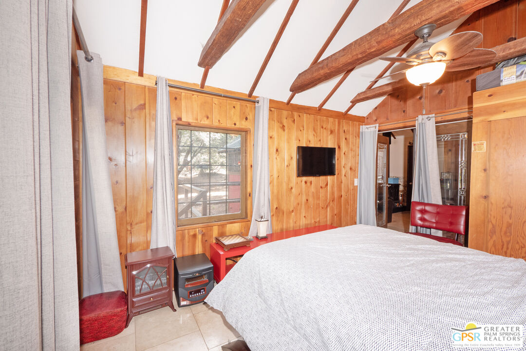 76 7 Oaks Road Angelus Oaks, CA 92305 - Photo 17 of 35 a bedroom with a large bed and a window