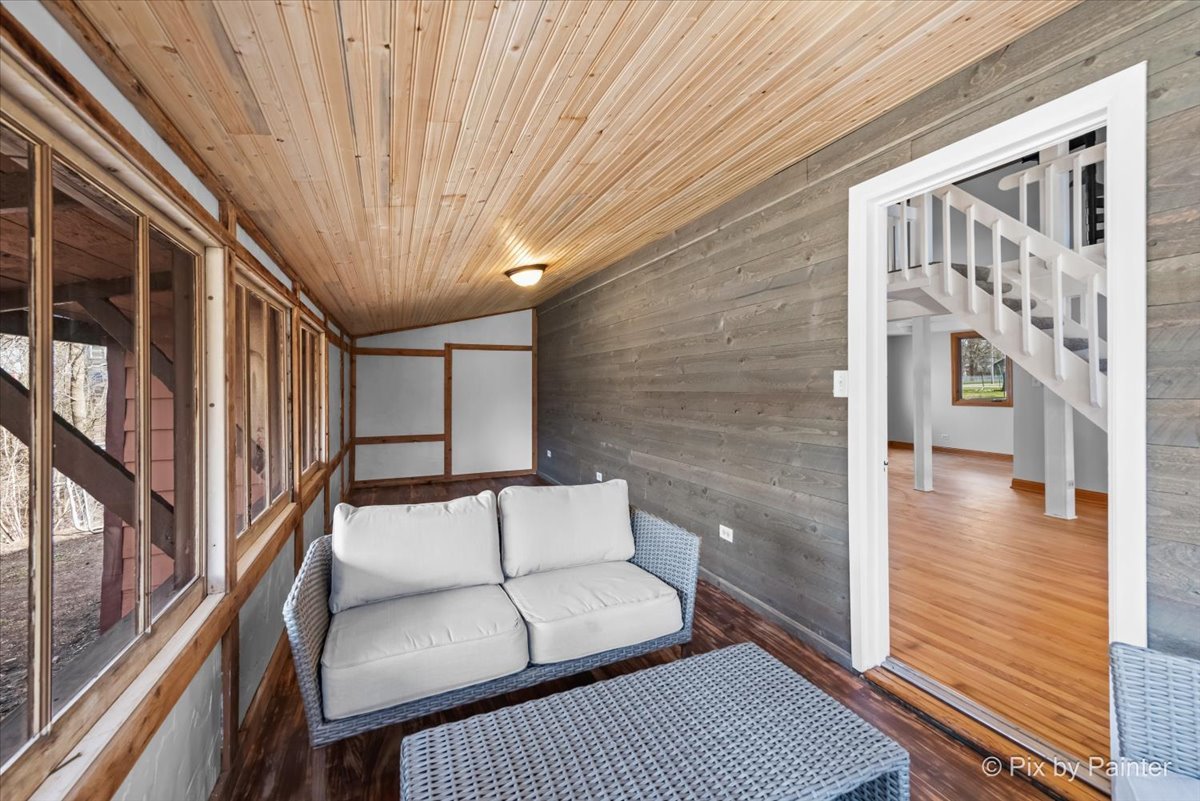 7611 Beverly Way Spring Grove, IL 60081 - Photo 13 of 33 a balcony with furniture and wooden floor