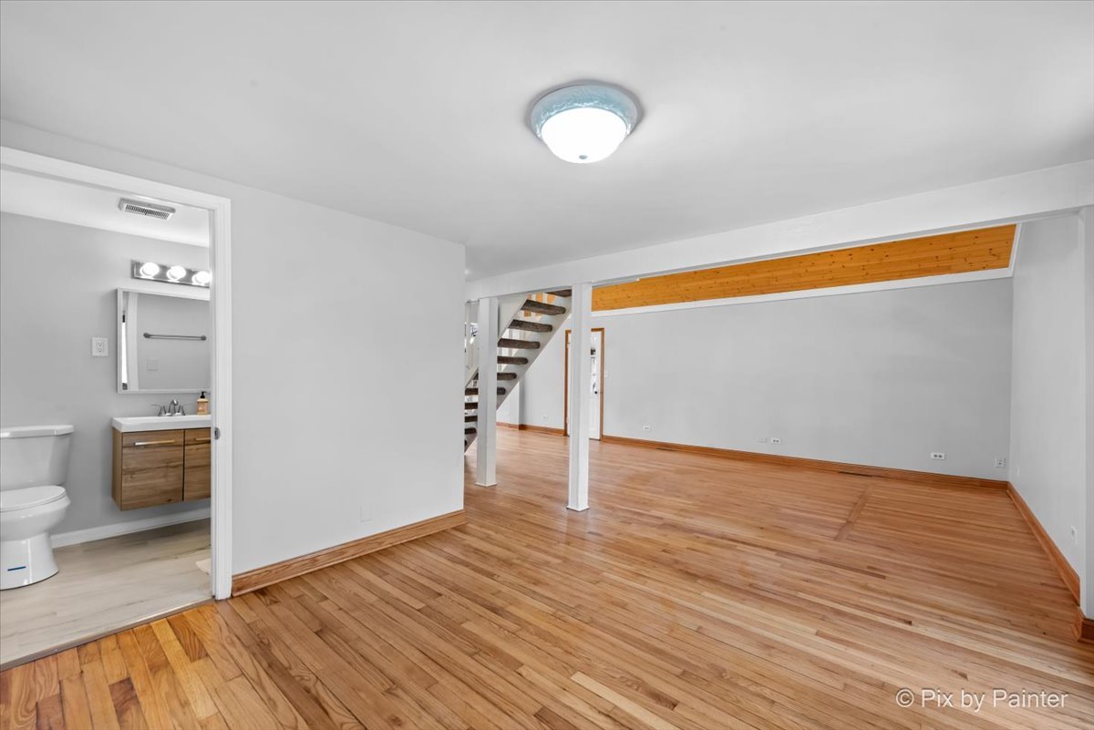7611 Beverly Way Spring Grove, IL 60081 - Photo 15 of 33 a view of empty room with wooden floor and fan
