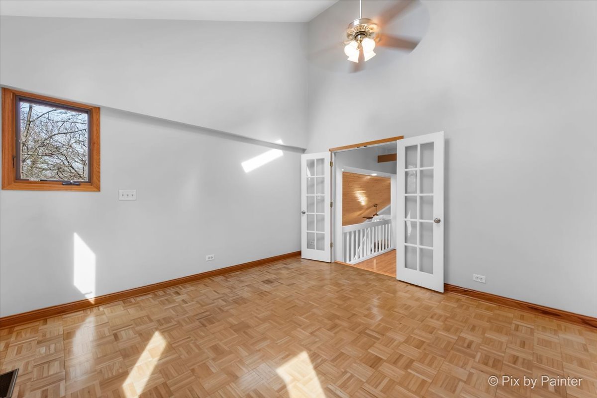 7611 Beverly Way Spring Grove, IL 60081 - Photo 21 of 33 a view of an empty room with window and wooden floor
