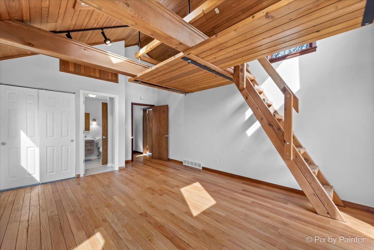 7611 Beverly Way Spring Grove, IL 60081 - Photo 23 of 33 a view of an empty room with wooden floor