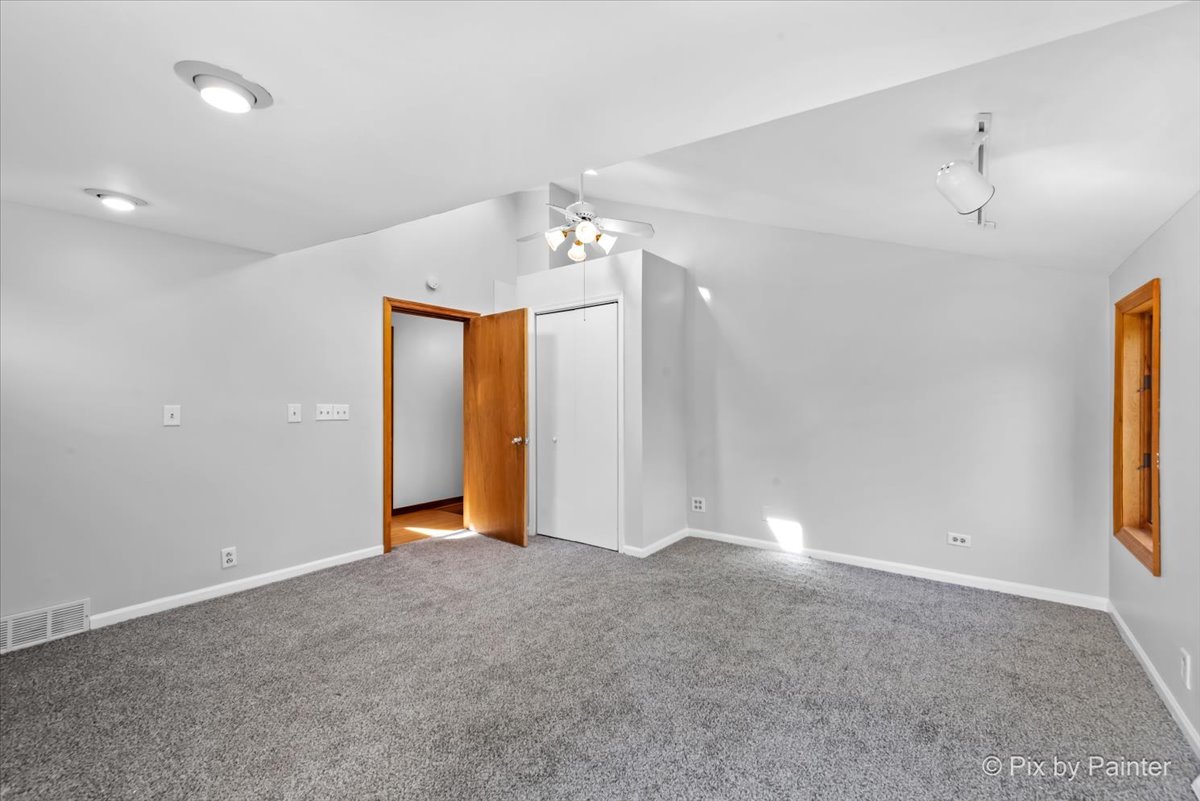 7611 Beverly Way Spring Grove, IL 60081 - Photo 26 of 33 a view of an empty room with a chandelier fan