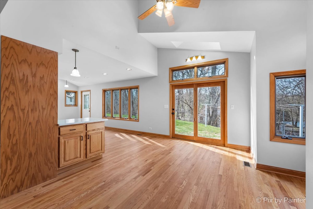 7611 Beverly Way Spring Grove, IL 60081 - Photo 8 of 33 an empty room with wooden floor and windows