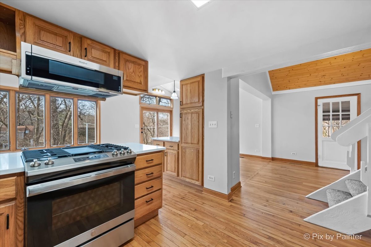 7611 Beverly Way Spring Grove, IL 60081 - Photo 9 of 33 a kitchen with stainless steel appliances granite countertop a stove and a refrigerator