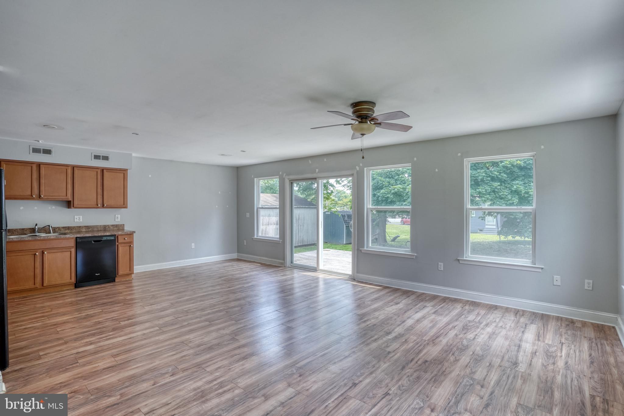 203 Hamilton Street Delaware City, DE 19706 - Photo 6 of 27 a view of an empty room with a window and wooden floor