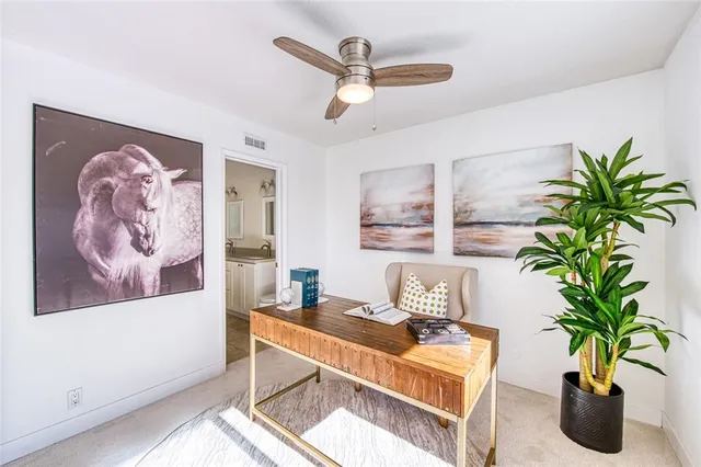 a living room with furniture potted plant and a chandelier