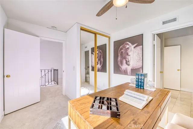 a living room with furniture large window and wooden floor