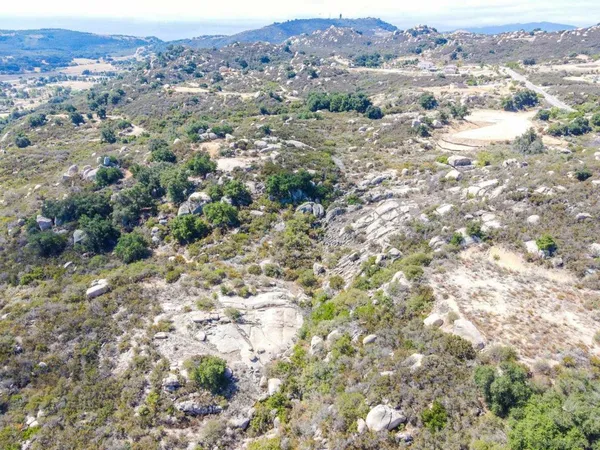 an aerial view of mountain with trees in the background