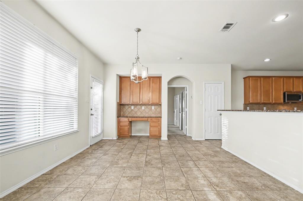 4902 Spring Lake Parkway Mansfield, TX 76063 - Photo 13 of 38 a view of a kitchen with a sink and a refrigerator