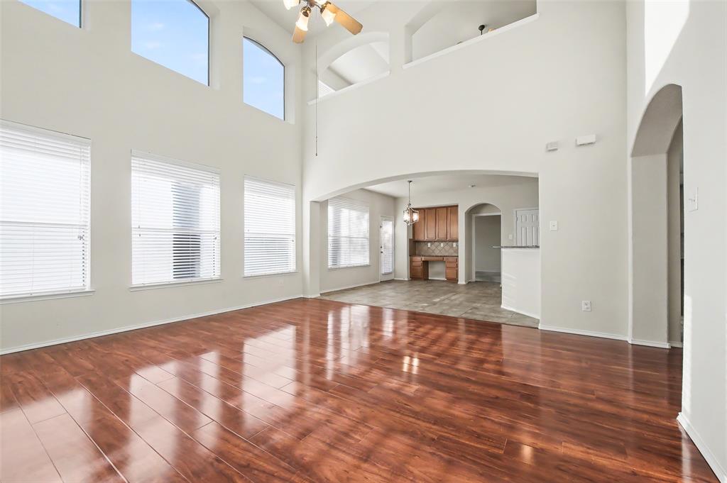 4902 Spring Lake Parkway Mansfield, TX 76063 - Photo 15 of 38 a view of an empty room with window and wooden floor