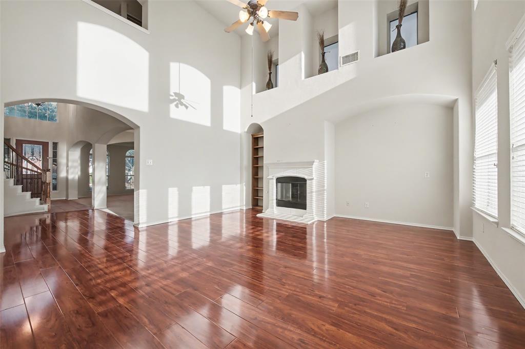 4902 Spring Lake Parkway Mansfield, TX 76063 - Photo 16 of 38 a view interior of a house livingroom and hallway with wooden floor