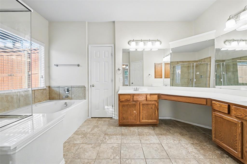 4902 Spring Lake Parkway Mansfield, TX 76063 - Photo 19 of 38 a spacious bathroom with a granite countertop tub sink shower and mirror