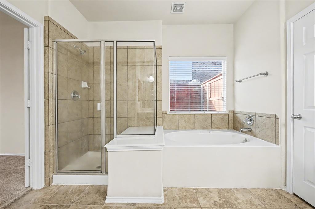 4902 Spring Lake Parkway Mansfield, TX 76063 - Photo 20 of 38 a bathroom with a shower and a bathtub