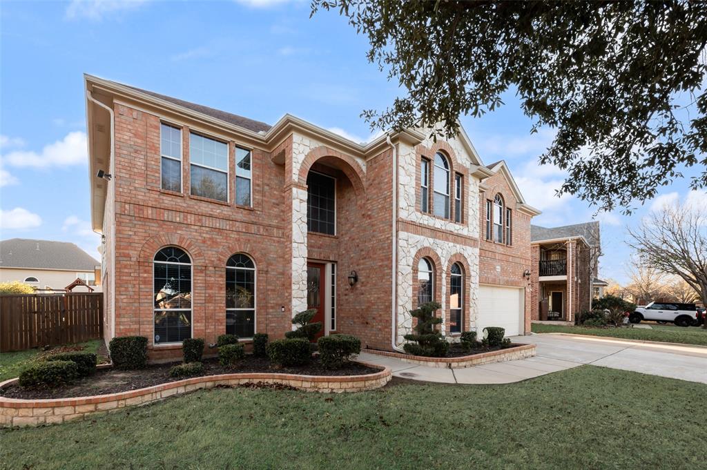 4902 Spring Lake Parkway Mansfield, TX 76063 - Photo 2 of 38 a front view of a house with a yard