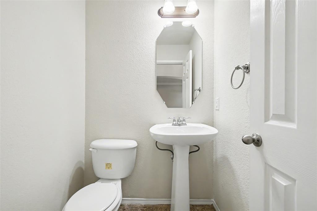 4902 Spring Lake Parkway Mansfield, TX 76063 - Photo 21 of 38 a bathroom with a toilet sink and mirror