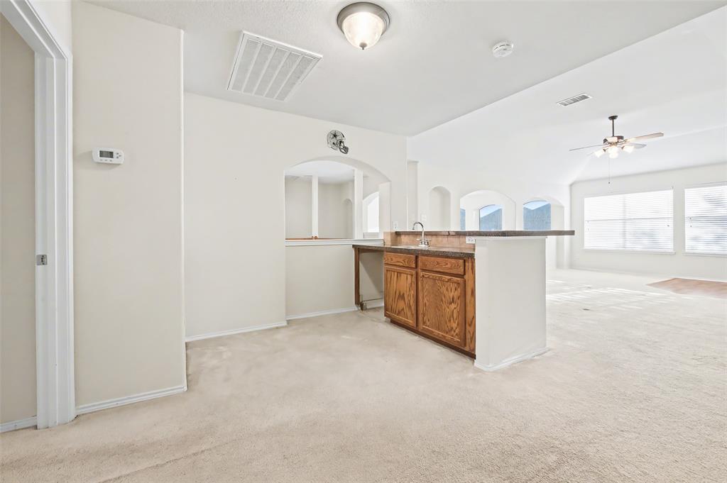 4902 Spring Lake Parkway Mansfield, TX 76063 - Photo 24 of 38 a kitchen with cabinets and window