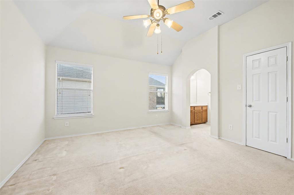 4902 Spring Lake Parkway Mansfield, TX 76063 - Photo 28 of 38 an empty room with chandelier fan and windows