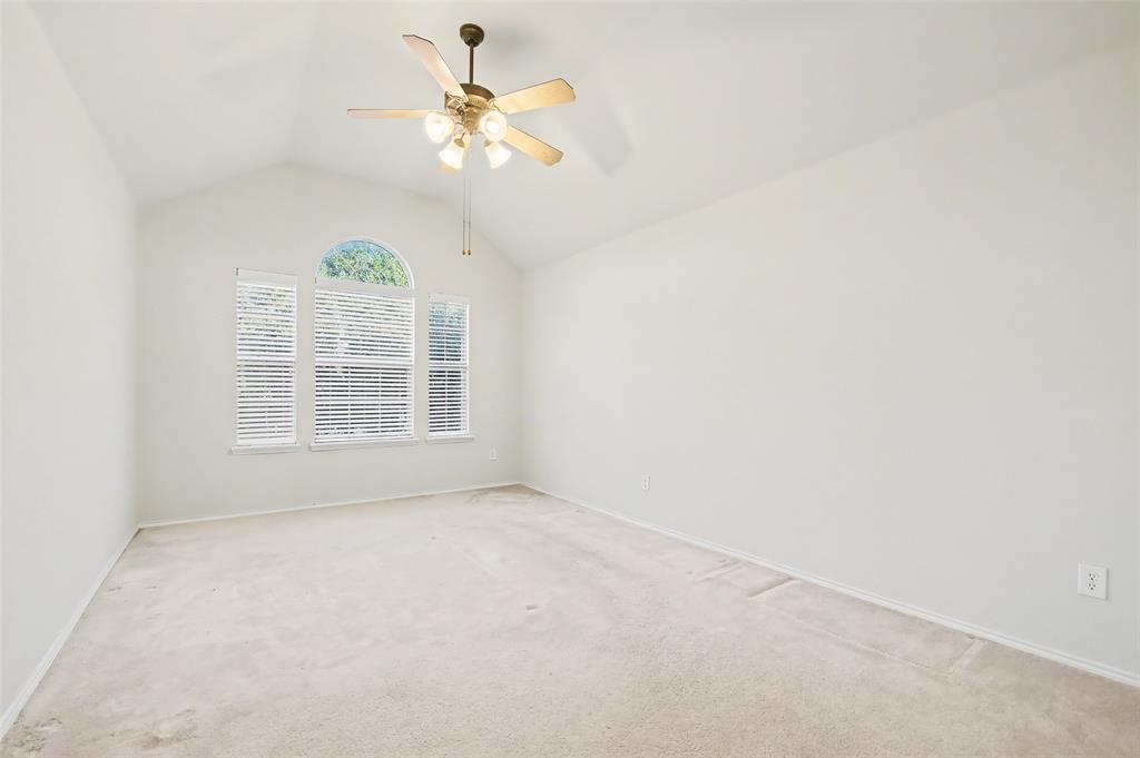 4902 Spring Lake Parkway Mansfield, TX 76063 - Photo 31 of 38 an empty room with windows and fan