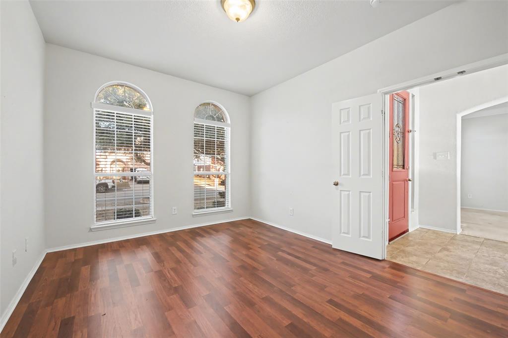 4902 Spring Lake Parkway Mansfield, TX 76063 - Photo 5 of 38 an empty room with wooden floor and windows
