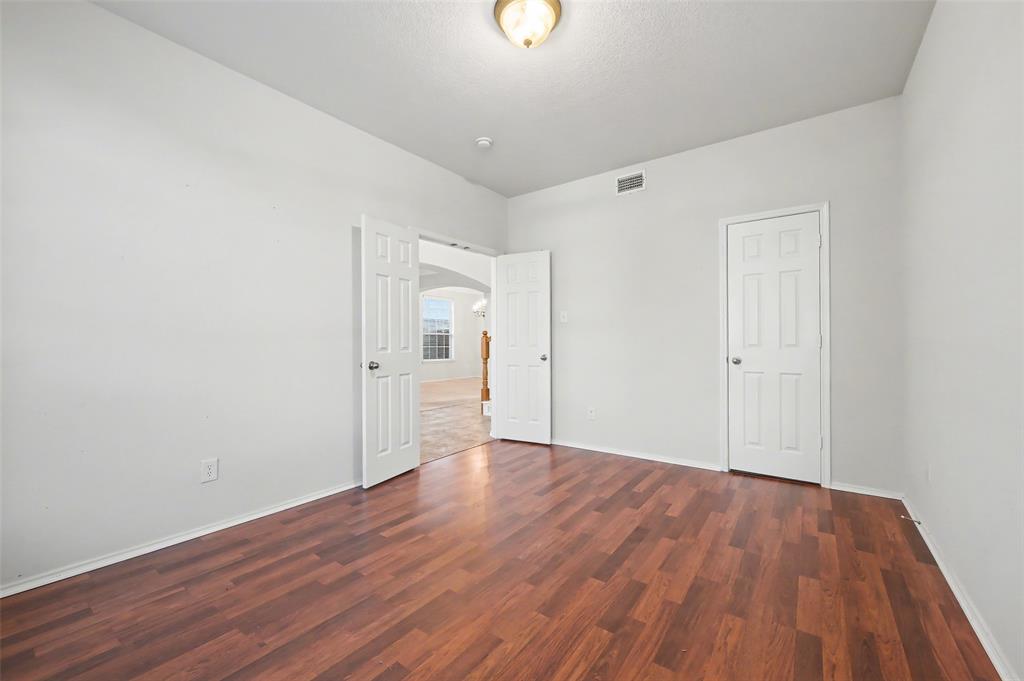 4902 Spring Lake Parkway Mansfield, TX 76063 - Photo 6 of 38 a view of an empty room with wooden floor