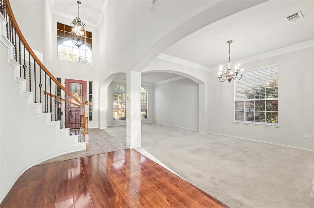 4902 Spring Lake Parkway Mansfield, TX 76063 - Photo 8 of 38 wooden floor in an empty room with a chandelier fan