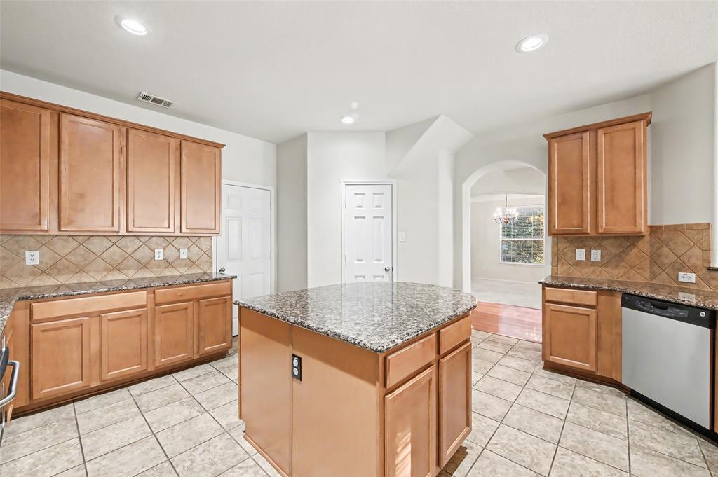 4902 Spring Lake Parkway Mansfield, TX 76063 - Photo 10 of 38 a kitchen with granite countertop sink and cabinets
