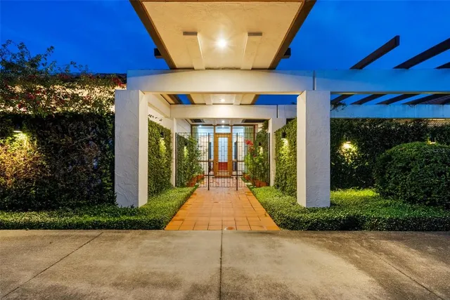 a view of a patio with a table and chairs under an umbrella