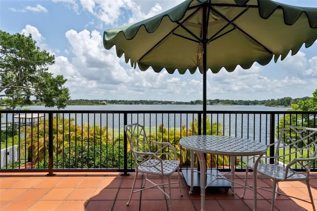 a bathroom with a granite countertop sink and a bathtub