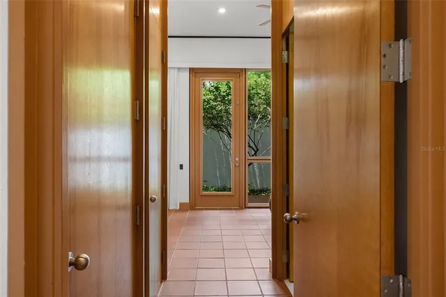 an aerial view of a house with swimming pool and yard