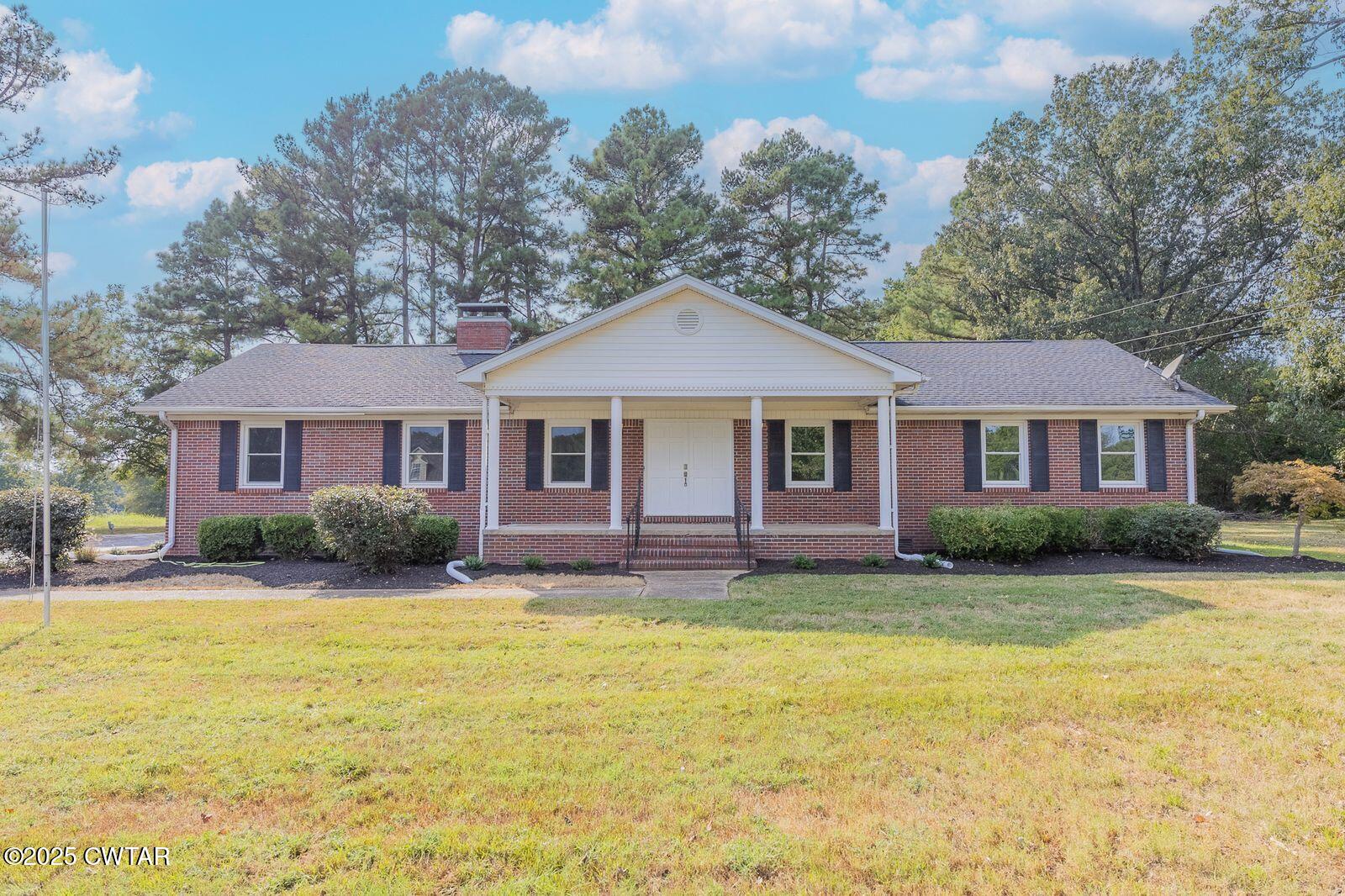 77 Upper Zion Road Brownsville, TN 38012 - Photo 1 of 27 a front view of a house with a garden