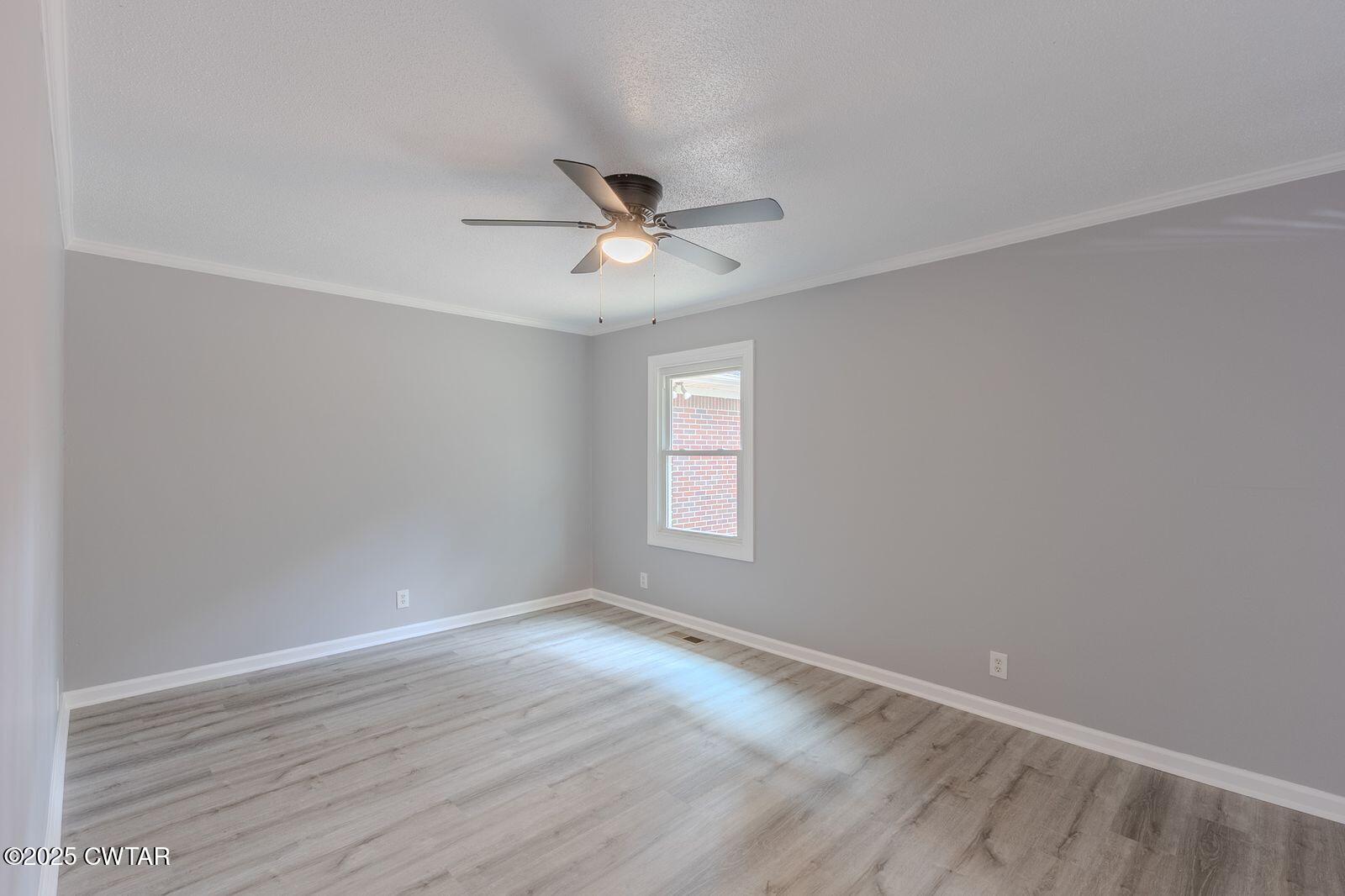 77 Upper Zion Road Brownsville, TN 38012 - Photo 11 of 27 a view of empty room with wooden floor and fan