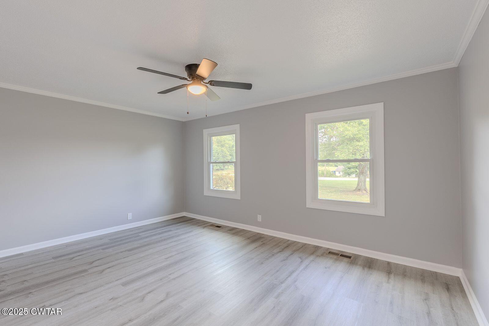 77 Upper Zion Road Brownsville, TN 38012 - Photo 15 of 27 a view of empty room with wooden floor and fan