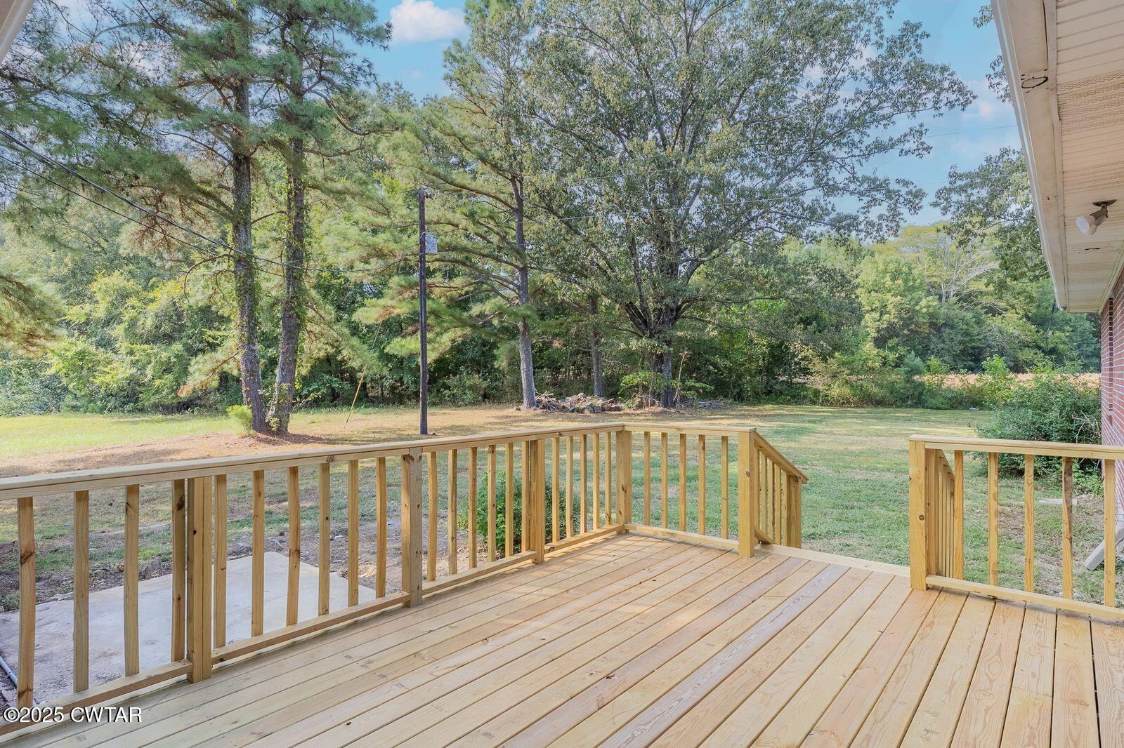 77 Upper Zion Road Brownsville, TN 38012 - Photo 21 of 27 a view of balcony with wooden floor and lake view
