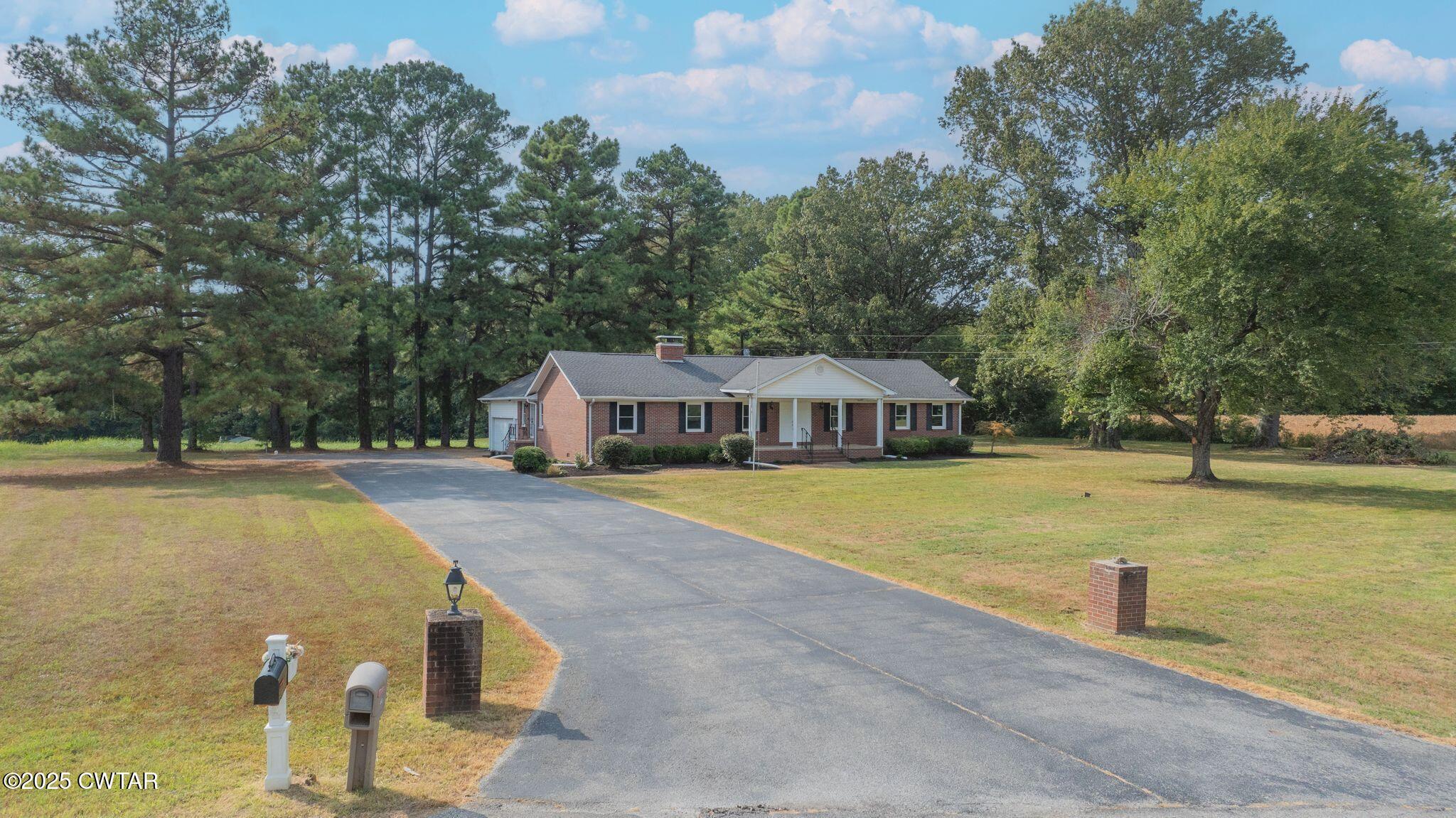 77 Upper Zion Road Brownsville, TN 38012 - Photo 26 of 27 a view of a swimming pool with lawn chairs and large trees