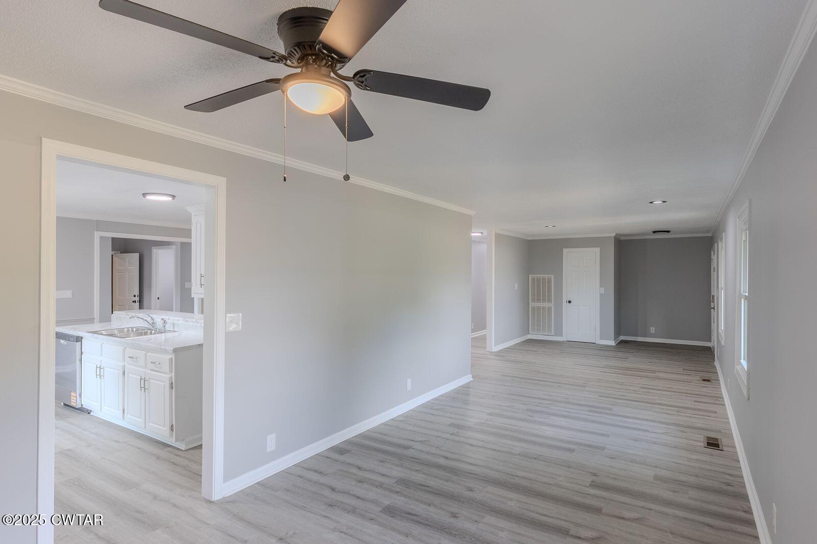 77 Upper Zion Road Brownsville, TN 38012 - Photo 6 of 27 wooden floor in an empty room with a window